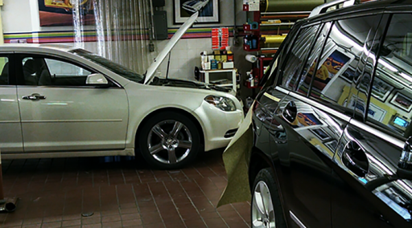 Two vehicles inside bob's auto body shop